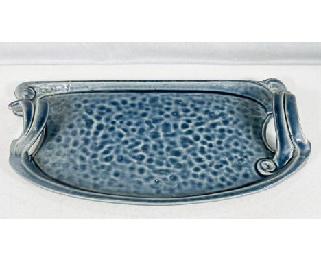 Bretby Art Pottery: - An unusual rounded rectangular tray with raised side handles under a blue glaze, impressed mark pat. no