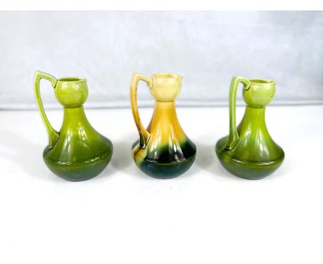 Bretby Art Pottery: - A small jug with slender neck and swelling body under yellow fading to green glaze, height 14cm, impres