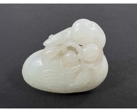 A Chinese carved jade coloured hard stone bird eating fruit with detailed decoration length 5.5cm