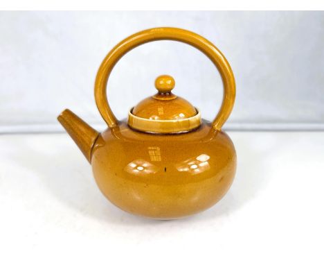 Linthorpe Art Pottery: A tea kettle of squat form, all over toffee coloured glaze, impressed mark, pattern no. 628 (minor hai