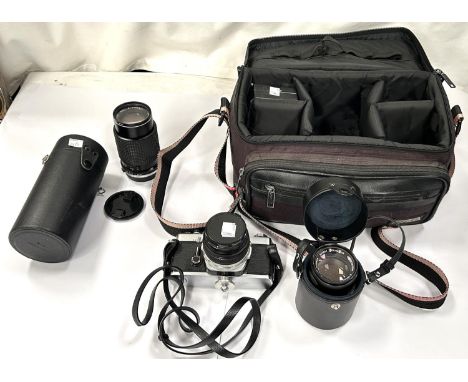 An Olympus SLR camera with various lenses, accessories and bag.