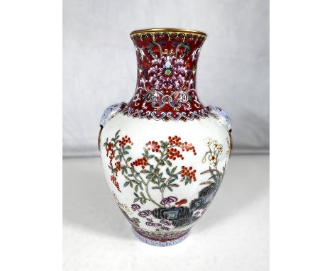 A Chinese ceramic famille rose vase with polychrome decoration to the body gilt 'handles' seal mark to base 21cm and a wooden