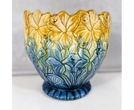 Ault Art Pottery: A circular tapering jardiniere with all over relief decoration of daffodils under a shaded blue/yellow glaz