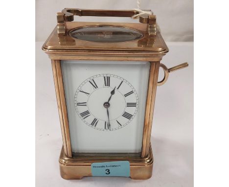 A large brass carriage clock with enamel face, striking movement etc. (glass a.f)