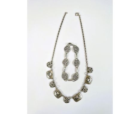 A white metal Scandinavian necklace with alternating links of long boats and Celtic knots; a white metal bracelet with pierce