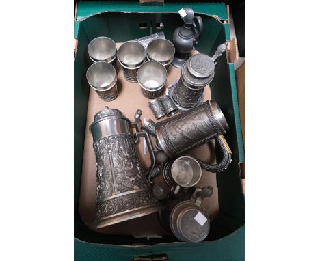 A large pewter stein decorated with a hunting scene; other similarly decorated steins,cups, tots etc