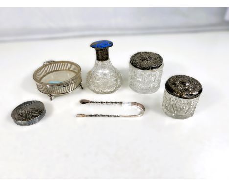 A circular pierced hallmarked silver bon-bon dish with glass liner; two silver top glass trinket jars; a cut scent bottle wit