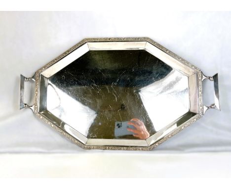 An Art Deco style stretched octagonal two handled silver plated tray with Celtic design border