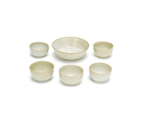A GROUP OF FIVE PALE CELADON CUPS AND A BOWLSong/Yuan DynastyComprising: five different moulded cups with lotus, floral and f