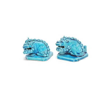 A PAIR OF UNUSUAL TURQUOISE GLAZED 'BUDDHIST LION' JOSS STICK HOLDERSKangxiEach with a recumbent Buddhist lion on a square ba