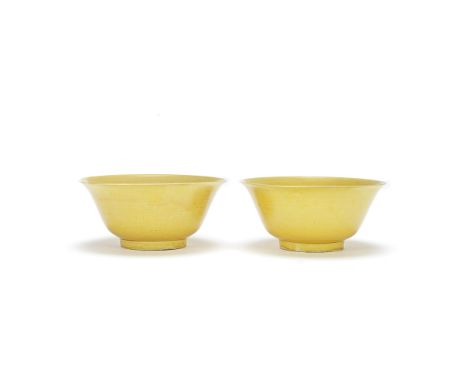 A NEAR PAIR OF YELLOW GLAZED BOWLSKangxiEach with gently rounded sides rising to a flaring rim, the interior and exterior cov