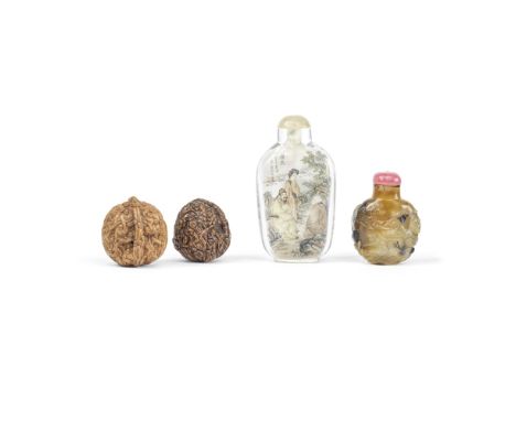 A PAIR OF CARVED 'WALNUTS' AND TWO SNUFF BOTTLES19th to 20th centuryComprising: two carved walnuts, the first with monkeys cl
