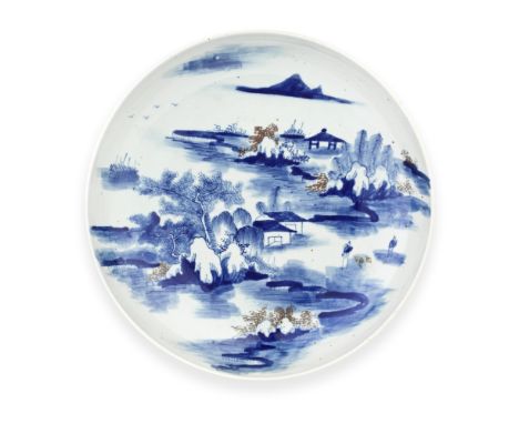 AN UNDERGLAZE-BLUE AND COPPER-RED GLAZED DISHKangxiPainted with a nocturnal river landscape with the moon on the top right an