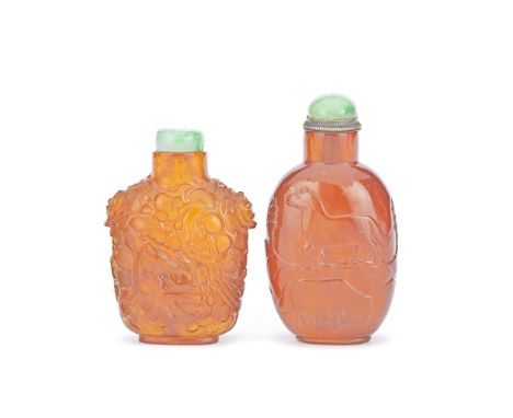 TWO CARVED AMBER SNUFF BOTTLES19th centuryThe first of compressed form, richly carved to each side with an exotic bird perche