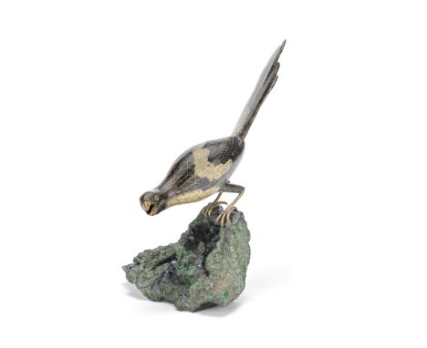 A RARE CLOISONNÉ MAGPIE ON A MALACHITE BOULDERQianlongElaborately cast as a magpie realistically enamelled in black with whit