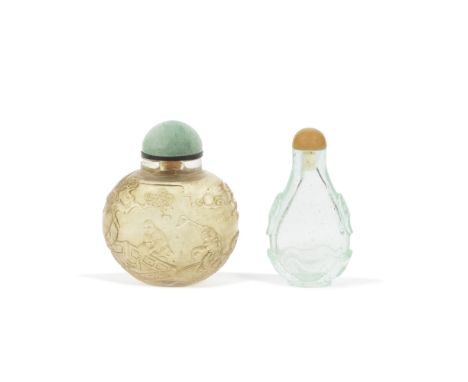 AN AQUAMARINE GLASS SNUFF BOTTLE AND A CARVED ROCK CRYSTAL BOTTLE19th centuryThe first of flattened pear-shape set on a neat 