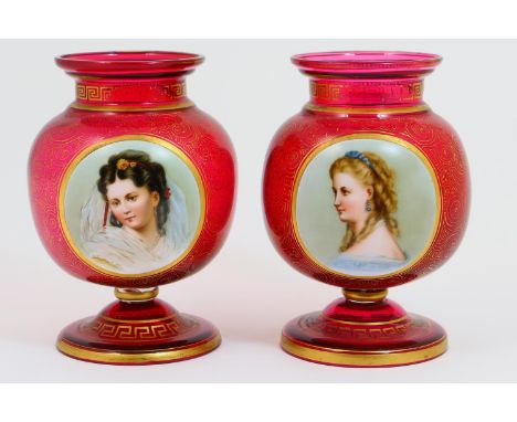 Pair of Victorian hand decorated ruby glass vases, circa 1870, footed bulbous form decorated with a raised portrait of a youn