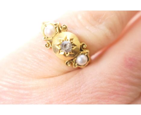 Late Victorian diamond and pearl ring, centred with a small old brilliant cut diamond, illusion set and flanked on either sid