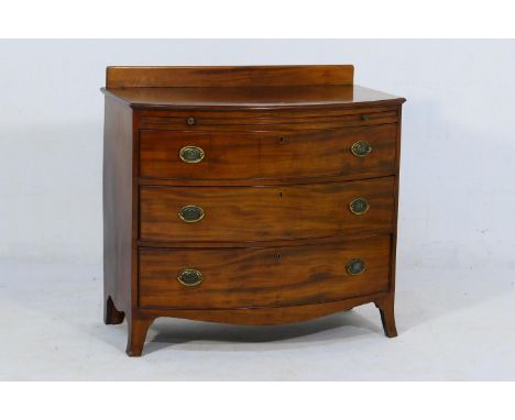 Mahogany bow front chest of drawers, 19th Century, fitted with a brushing slide above three long graduating drawers, all with