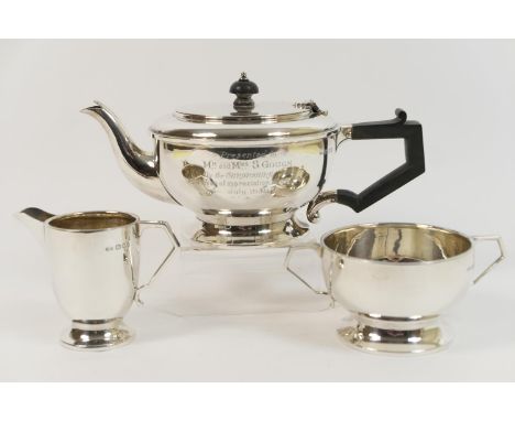 Silver three piece presentation tea service, London 1936, comprising lidded teapot, sugar basin and milk jug, all of plain ci