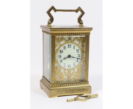 French brass carriage clock, circa 1930, the brass embellished cream dial with Arabic numerals, bordered with brass fretted g