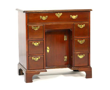 Mahogany kneehole dressing table, in the Georgian style, having a top with moulded edge over a long upper drawer, with three 