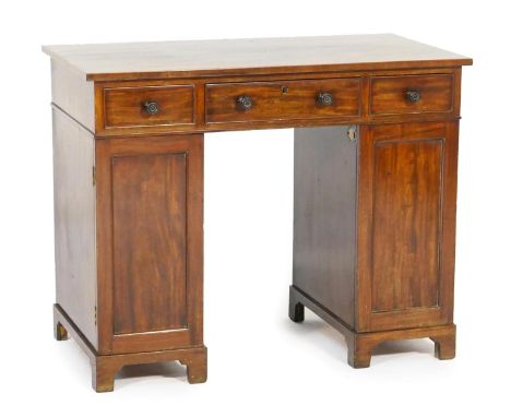 Mahogany kneehole dressing table, in the manner of Gillows, early 19th Century, fitted with three frieze drawers with turned 