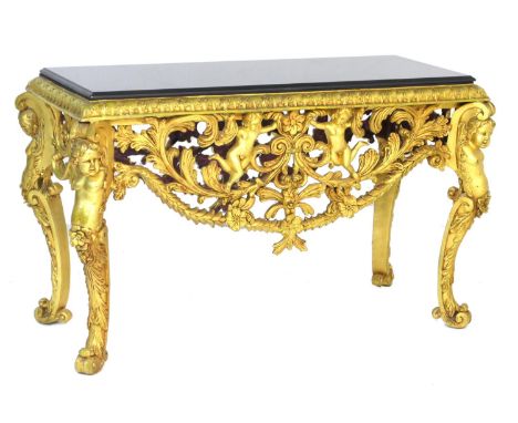 Italian style gilt metal console table, black granite top over a border of stiff acanthus leaves and openwork apron festooned