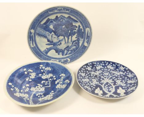 Two Japanese porcelain prunus blossom blue and white plates, 31.5cm and 34cm diameter; also a further Japanese blue and white