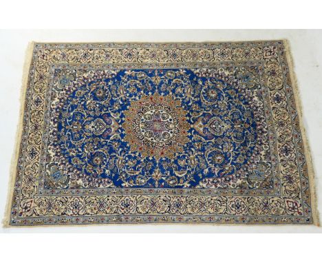 Iranian Isfahan woollen carpet, having a blue field dispersed with palmettes within a fawn flowerhead border, size approx. 28