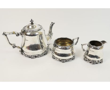 George V silver three piece tea service, by Martin Hall &amp; Co., Sheffield 1911, comprising teapot with hinged cover, ivory