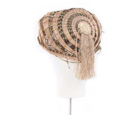 A plaited ribbon and straw quill-work turban-like hat, 1800-1810, asymmetric with ivory silk cord rosette and fringes to one 