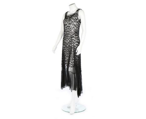 A black bugle beaded chiffon evening dress, circa 1930, vertically beaded in leopard-spot effect, bias-cut, gored flared skir