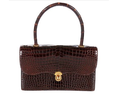 An Hermès chocolate brown crocodile handbag, 1960s, crocodylus porosus, stamped 'Hermès Paris', with gilt rope twist closure 