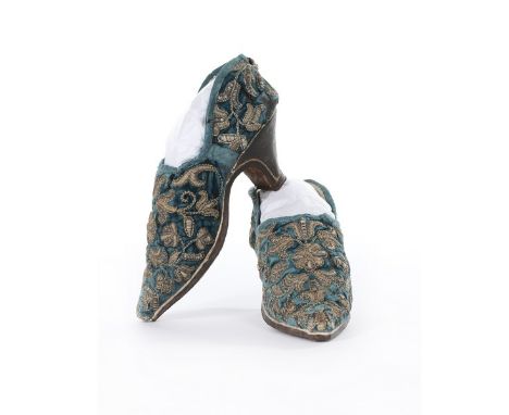 A fine and important pair of embroidered velvet lady's shoes, English, circa 1650, the blue velvet uppers embroidered in high