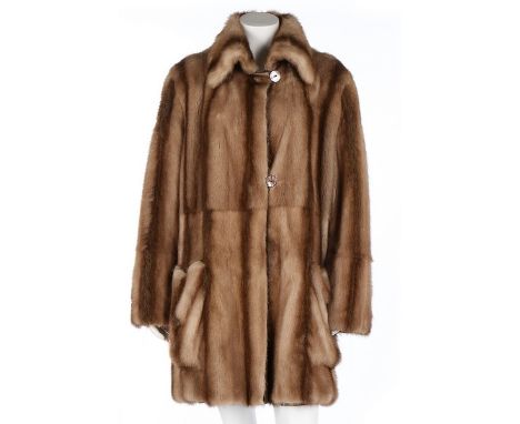 A Fendi light brown mink coat, probably 1990s, labelled, knee-length and with oversized front pockets, the mother of pearl bu