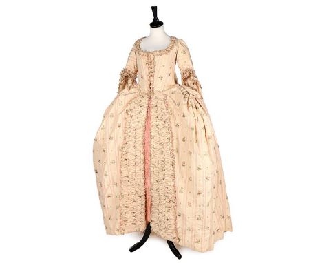 A striped and floral brocaded pink silk robe à la Française, 1770s, with trained sack-back, wide pannier skirt shapings, grad