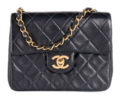 A Chanel quilted navy leather bag, 1990s, stamped to interior, with authentication card no 2724973, with gilt clasp and chain