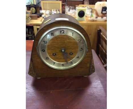 An oak cased two hole mantel clock
