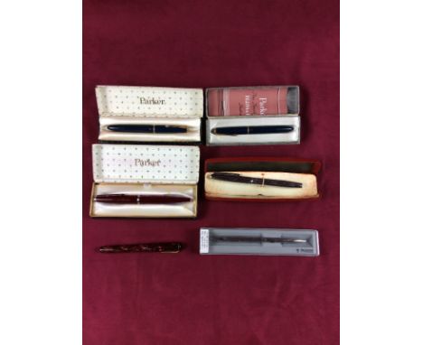 Four various Parker pens; a Burnham fountain pen and one other pen