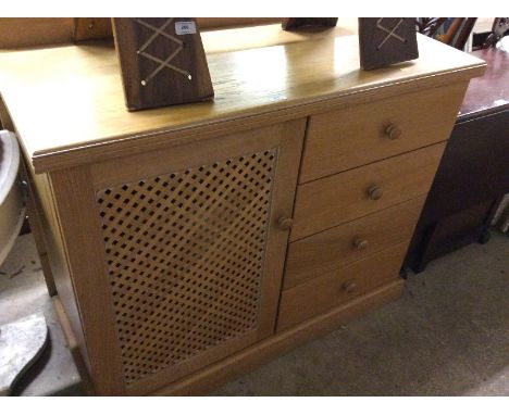 A light oak effect side cupboard fitted four drawers 