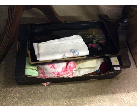 A Japanese black lacquered tray and a box of various textiles