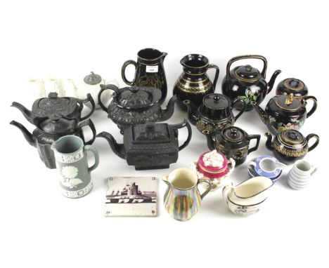 A large collection of 19th century English pottery and porcelain. Including: basalt and Jackfield type teapots and jugs, a Du