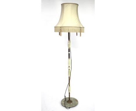 An early 20th century standard lamp. The brass column covered with alabaster sections, on a circular alabaster base, with cre