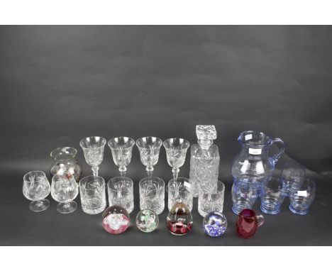 An assortment of glassware. To include a Caithness 'sugar fruits' paperweight, blue glass pitcher with four matching glasses,