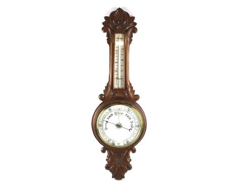 A late 19th/early 20th century oak framed aneroid banjo-shaped barometer. With foliate and palmette carved frame, 81cm high (