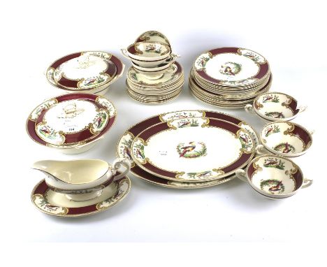 A mid-century Myott ceramic six setting part dinner service, signed A Roberts. Decorated with scenes showing a stylised phoen