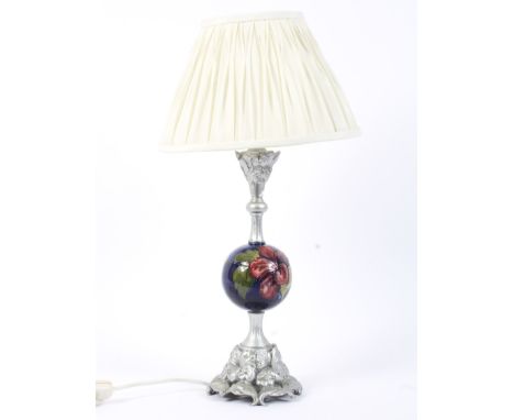 A Moorcroft Pottery Hibiscus pattern and silvered resin mounted table lamp. The blue-ground globular pottery mid-section prob