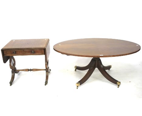 A mahogany oval coffee table and a sofa table. The sofa table with two real and two faux drawers, raised on lyre supports wit