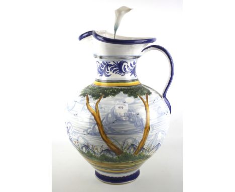 A large 20th century single handed pitcher. Decorated with a landscape scene, H52cm